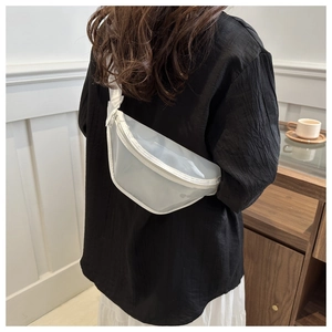 Detailed view of a white translucent waterproof PVC chest bag worn on a female model