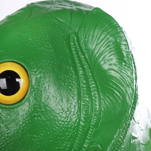 Macro detail of green fish latex mask showing realistic skin texture and yellow eye