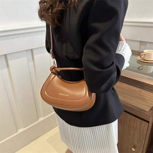 Brown retro half-moon shoulder bag in matte faux leather with vintage brass fashion lettering