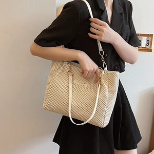 Minimalist beige woven straw tote bag with dual shoulder straps and fashion tag
