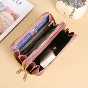 Pink PU leather crossbody bag with dual zippers and large interior capacity
