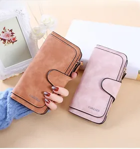 Detail of long women's wallets in caramel and pink with buckle and zipper closure