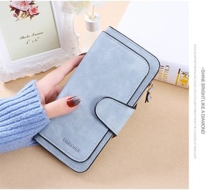 Detail of light blue matte long wallet with snap buckle and FOREVER embossed text