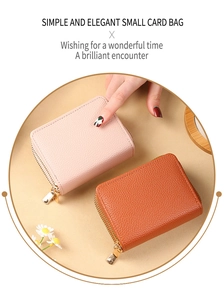 Close-up of pink and tan pebble leather accordion card wallets with metal zippers