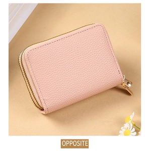 Detailed side view of pink litchi grain leather card holder with gold zipper closure