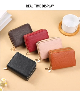 Detailed view of accordion-style PU leather card holders in five vibrant colors with gold zippers
