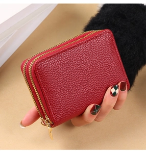Close-up of red lychee pattern PU leather card holder with dual golden metal zippers