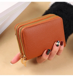 Close-up of brown litchi pattern PU leather double zipper card wallet held in hand