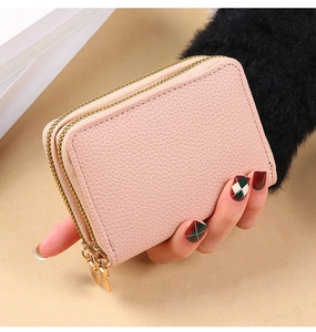 Detail of pink pebbled leather double-zipper card holder with accordion compartments