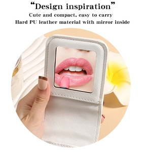 Detail of white PU leather folding cosmetic mirror with cross texture and internal mirror