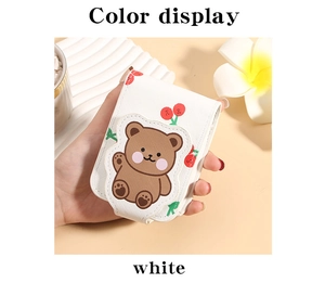 Detail of white PU leather lipstick case with cute brown bear and cherry pattern