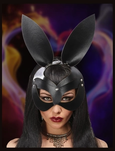 Detail of black faux leather bunny mask with metal studs and long ears for parties
