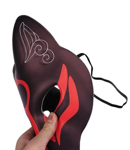 Detail of purple translucent fox mask with red flame patterns and elastic head strap