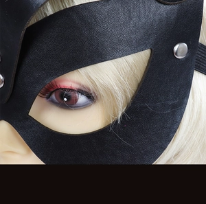 Macro shot of black leather cat mask showing detailed texture and silver metal rivets