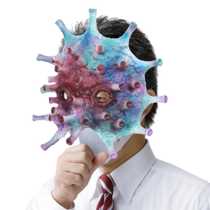 Male model wearing a realistic virus-shaped latex mask while coughing in an office setting