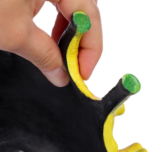 Close-up of a crown-shaped resin mask with textured black and yellow finish detailing