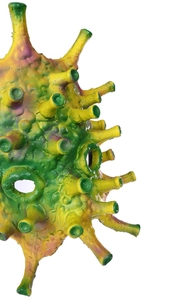 Close-up of a green latex virus mask with yellow spikes and purple dots for Halloween