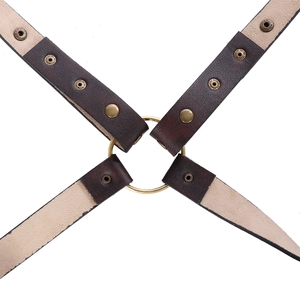 Close-up of medieval leather pauldron straps with vintage bronze metal rings and rivets