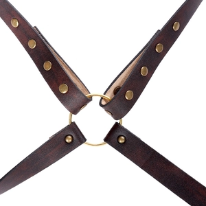 Detail of medieval Viking faux leather shoulder armor with rivets and a central ring