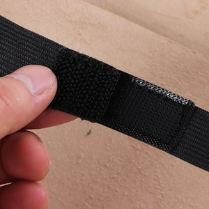Detail of black adjustable elastic strap with velcro closure for viking shoulder armor