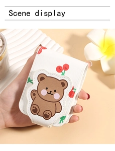 Detail of portable cartoon bear lipstick pouch with mirror and cute cherry pattern