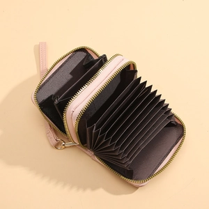 Porte-cartes accordéon en cuir rose avec fermeture éclair dorée et fentes multiples