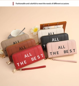 Close-up of stylish long leather wallets in various colors with wristlets and gold zippers