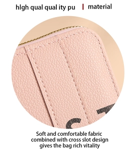 Detail of pink PU leather purse showing lychee texture, stitching and metal zipper
