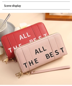 Detail of red and pink pebbled leather long wallets with ALL THE BEST text and wristlets