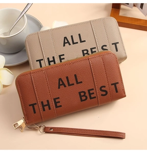 Detail of lychee textured leather long wallets with ALL THE BEST print and gold zippers