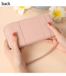 Detail of pink long wallet with litchi texture, double stitching and gold zipper back view