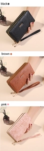 Close-up of long zip wallets with floral embossing in black, brown and pink colors