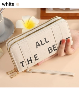Close-up of beige dual-zipper long wallet featuring All The Best print and wrist strap
