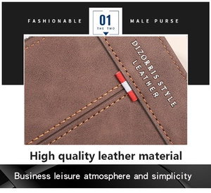 Detail of brown leather wallet featuring contrast orange stitching and tri-color ribbon trim