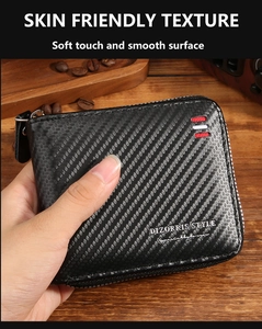 Macro shot of carbon fiber texture and brand logo on a compact men's zipper wallet