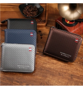 Detail of four carbon fiber pattern wallets in various colors on a wooden surface