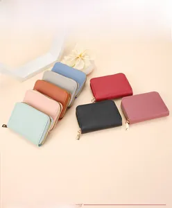 Detailed overhead view of assorted colorful lychee grain leather card holders with zippers