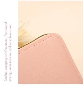 Macro shot of durable leather card holder with gold zipper and reinforced stitching