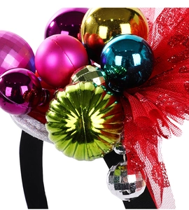 Close-up of colorful Christmas ball ornaments and red sequin mesh on a festive headband