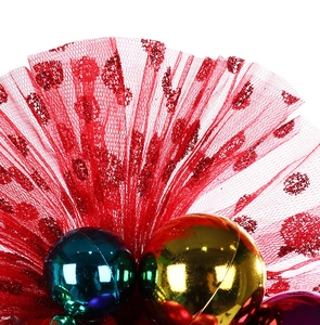 Close-up of mesh tulle fans and shiny colorful bells for Christmas party headband decor