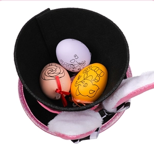 Easter rabbit hat detail with pink sequins, plush ears and colorful decorative eggs