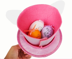 Pink felt bunny headband hat holding three colorful decorated easter eggs for kids