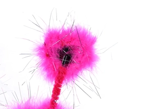 Close-up of pink feathers and silver tinsel details on a festive party headband