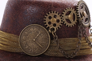 Macro detail of steampunk top hat with brass gears, chains and vintage clock dial