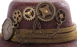 Macro shot of steampunk mini hat with vintage brass gears, clock face and fine chains