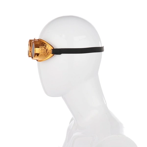 Detail view of retro gold steampunk goggles with gears and engravings on a white mannequin