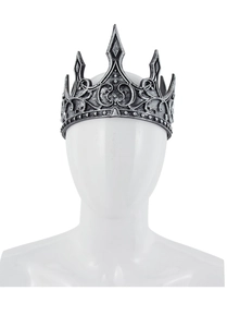 Detail of vintage silver crown with embossed scroll patterns and antique texture