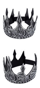 Macro detail of silver medieval king crown showing relief patterns and gothic engraving