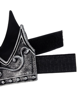 Detail of vintage silver crown with relief patterns and adjustable velcro strap