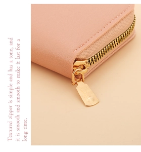 Detail of premium pale pink leather card holder with smooth light gold metal zipper